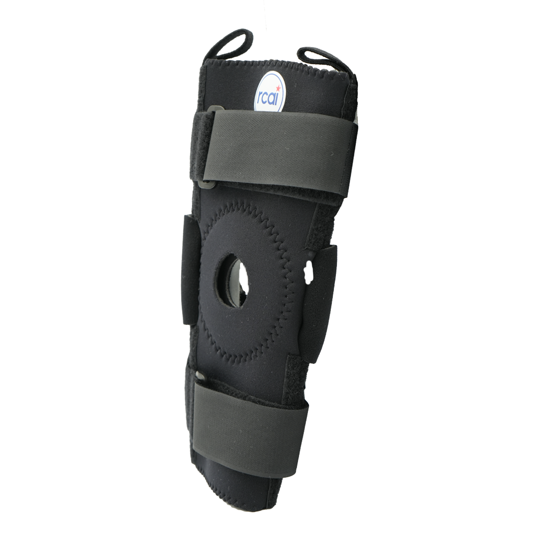 Black hinged knee brace with circular patella opening, adjustable Velcro straps, and small RCAI logo patch, made in the USA, .