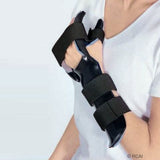 Black RCAI dorsal resting hand orthosis with finger separators, secured with three adjustable Velcro straps, worn on left.