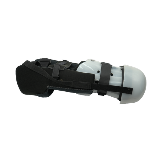 White rigid lower leg dressing with black adjustable straps and padding, designed for below-knee amputation support, made in .
