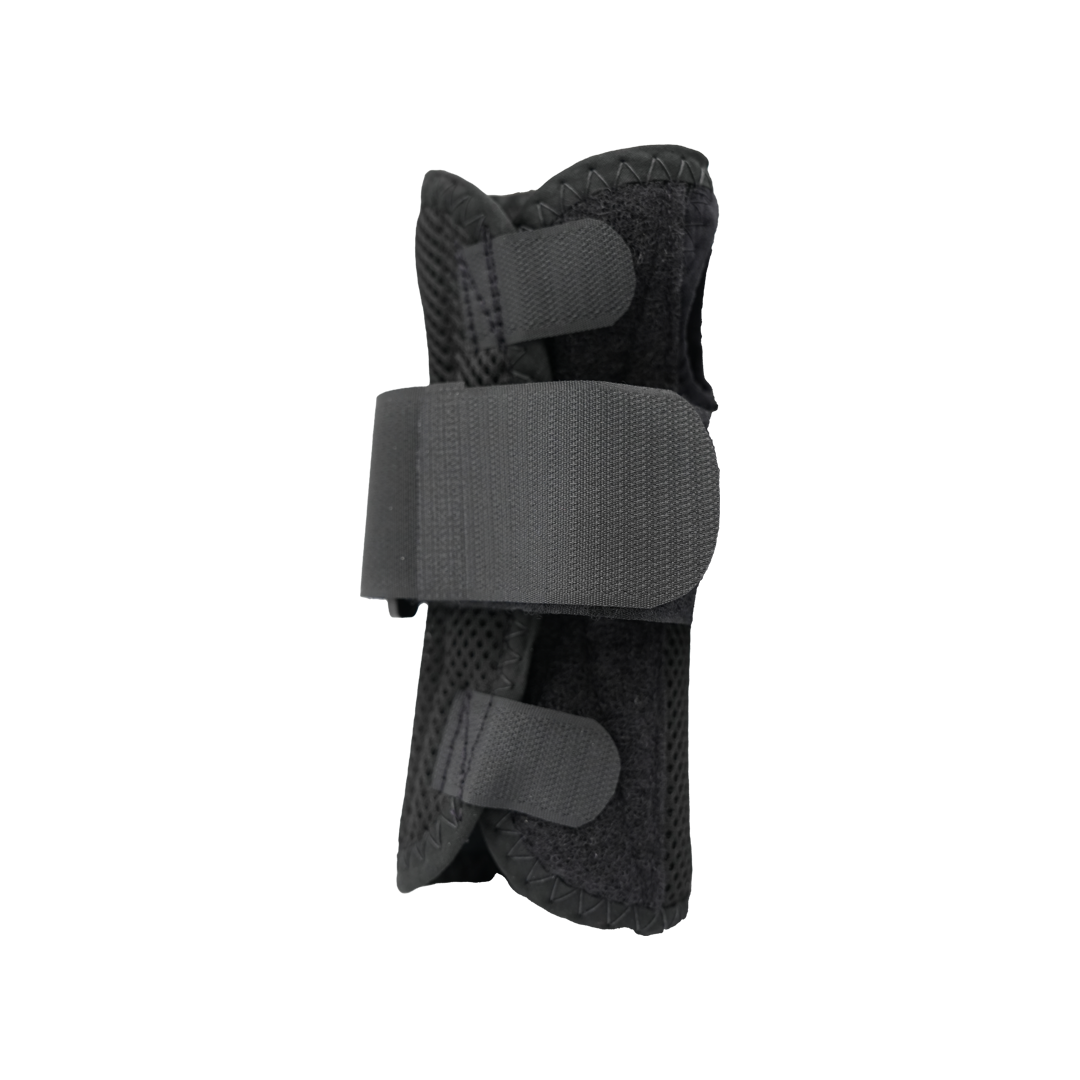 Black ambidextrous wrist brace with adjustable wide strap and two smaller velcro closures, breathable mesh fabric, made in.