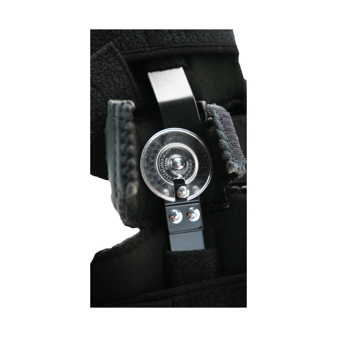 Close-up of black Flex Pop Elbow brace hinge mechanism with metal adjustment dial, made in the USA, best orthopaedic braces.